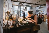 Gioielleria donna incisione metallo al banco da lavoro — Foto stock