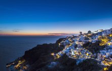 Casas de acantilados iluminadas por la noche, Atenas, Attiki, Grecia, Europa - foto de stock