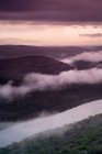Fog rolling over rural hillside — Stock Photo