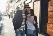 Романтична пара цілується на сонячній вулиці — стокове фото