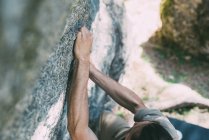 High angle view of young man climbing on boulder — Stock Photo