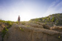 Distant view of teenage girl at quarry against blue sky — Stock Photo