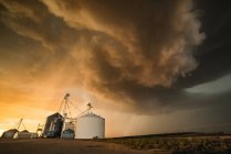 Strong storm above town of Dalhart with strong winds, heavy rain and hail, grain silo in foreground, Dalhart, Texas, USA — Stock Photo