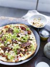 Frisee lardon pizza on plate, close-up — Stock Photo