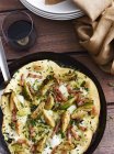 Mustard, brussel sprout and pancetta pizza in pizza dish, elevated view — Stock Photo