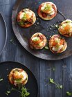 Mini lobster pizzas on serving plate, overhead view — Stock Photo