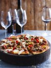 Spicy pork pizza on serving board, close-up — Stock Photo