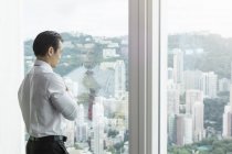Businesswoman looking out of window — Stock Photo