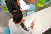 Cropped view of students with notebooks — Stock Photo