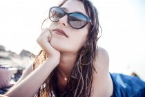 Portrait of young woman in shades on beach, Odessa, Ukraine — Stock Photo