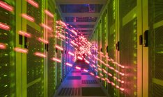 Interior of data centre, lights trails showing travelling data — Stock Photo