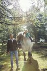 Couple in woodland horse riding, Tirol, Steiermark, Austria, Europe — Stock Photo