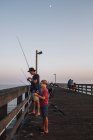 Father and son on pier fishing, Goleta, California, United States, North America — Stock Photo