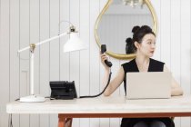 Young woman receptionist at work place — Stock Photo