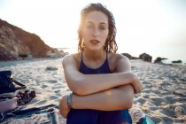 Retrato de uma jovem mulher sentada na praia — Fotografia de Stock