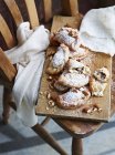 Cannoli calzone dusted with sugar, on serving board — Stock Photo