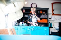 Woman at reception desk of quirky hair salon — Stock Photo