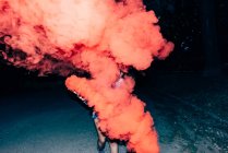Woman holding flare in park at night — Stock Photo