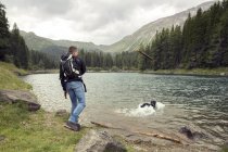 Man with dog hiking by lake, Tirol, Steiermark, Austria, Europe — Stock Photo