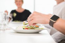 Businesswomen at working lunch in office — Stock Photo