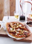 Spanish style pizza on wooden board in kitchen — Stock Photo