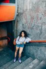 Young woman at bottom of stairs, Milan, Italy — Stock Photo