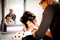 Woman working in quirky hair salon — Stock Photo