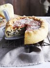 Chicago deep dish pizza, on cooling rack, close-up — Stock Photo