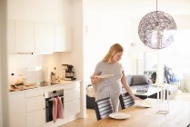 Pregnant young woman laying dining table — Stock Photo