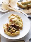 Braised goat and cabbage calzone on white plate — Stock Photo