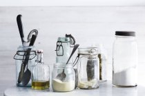 Jars of ingredients and kitchen utensils — Stock Photo