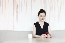 Woman having coffee break with phone — Stock Photo