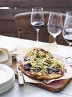 Blood sausage pizza on serving board — Stock Photo