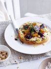 Beetroot with goats cheese and hazelnuts pizza on white plate — Stock Photo