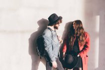 Young couple standing at train station, pensive expressions — Stock Photo