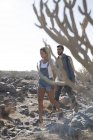 Young hiking couple walking over rocks, Las Palmas, Canary Islands, Spain — Stock Photo