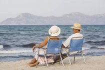 Couple on deckchairs on beach, Palma de Mallorca, Spain — Stock Photo