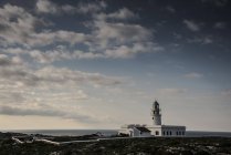 Whitewashed lighthouse on coast, Fornells, Menorca, Spain — Stock Photo