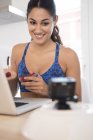 Woman making video call while eating fruits — Stock Photo