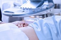 Ausgeschnittener Blick des Sonographen beruhigt schwangere Patientin — Stockfoto