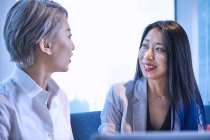 Woman looking at colleague smiling — Stock Photo
