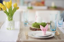 Bunny ear napkin at easter table place setting — Stock Photo