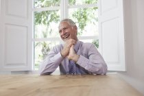 Businessman looking away laughing — Stock Photo