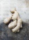 Top view of ginger root on shabby tabletop — Stock Photo
