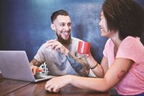 Multi ethnic hipster couple in cafe using laptop, Shanghai French Concession, Shanghai, China — Stock Photo