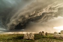 Storm clouds over rock formations in field, Lamar, Colorado, United States, North America — Stock Photo