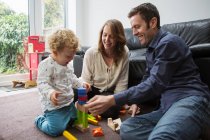 Parents and baby boy playing with building blocks — Stock Photo
