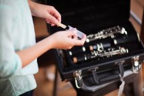 Young clarinettist putting her clarinet in case — Stock Photo