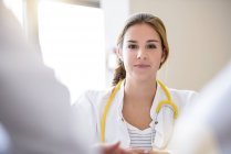 Portrait of female doctor in meeting, differential focus — Stock Photo