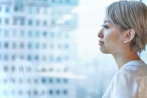 Portrait of businesswoman looking out of window — Stock Photo
